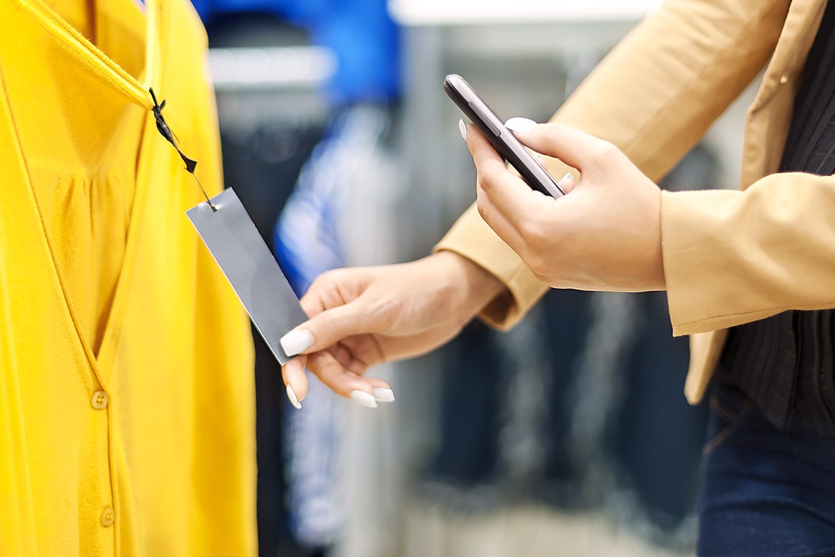 Woman using mobile in retail store
