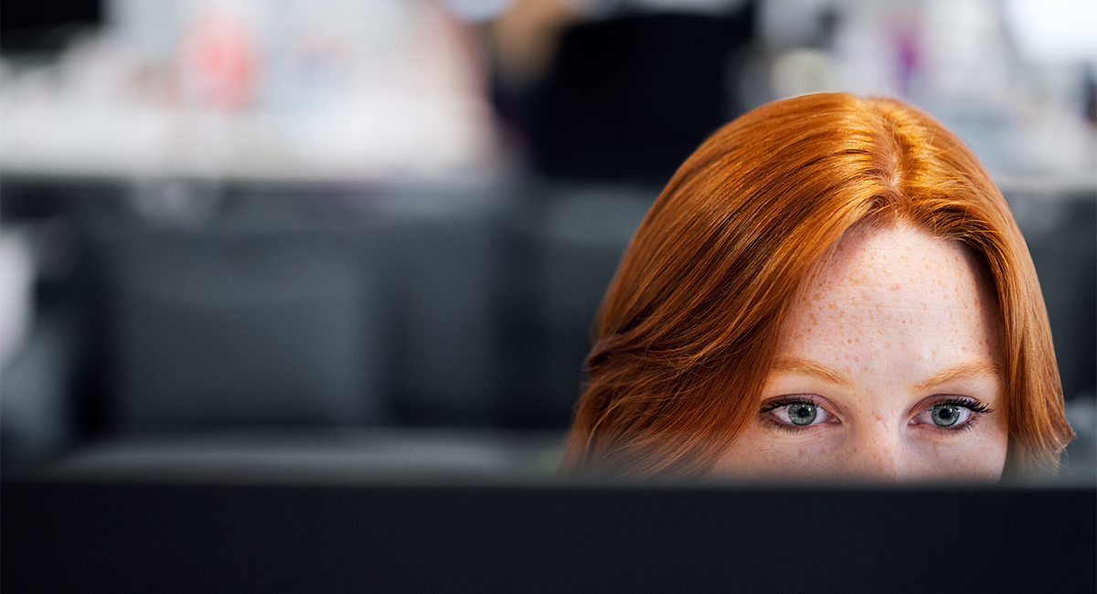 Redhead woman working at her computer
