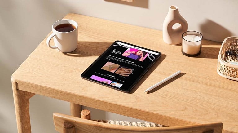 Mockup scene of a tablet on a light wood desk featuring Pandora Me page