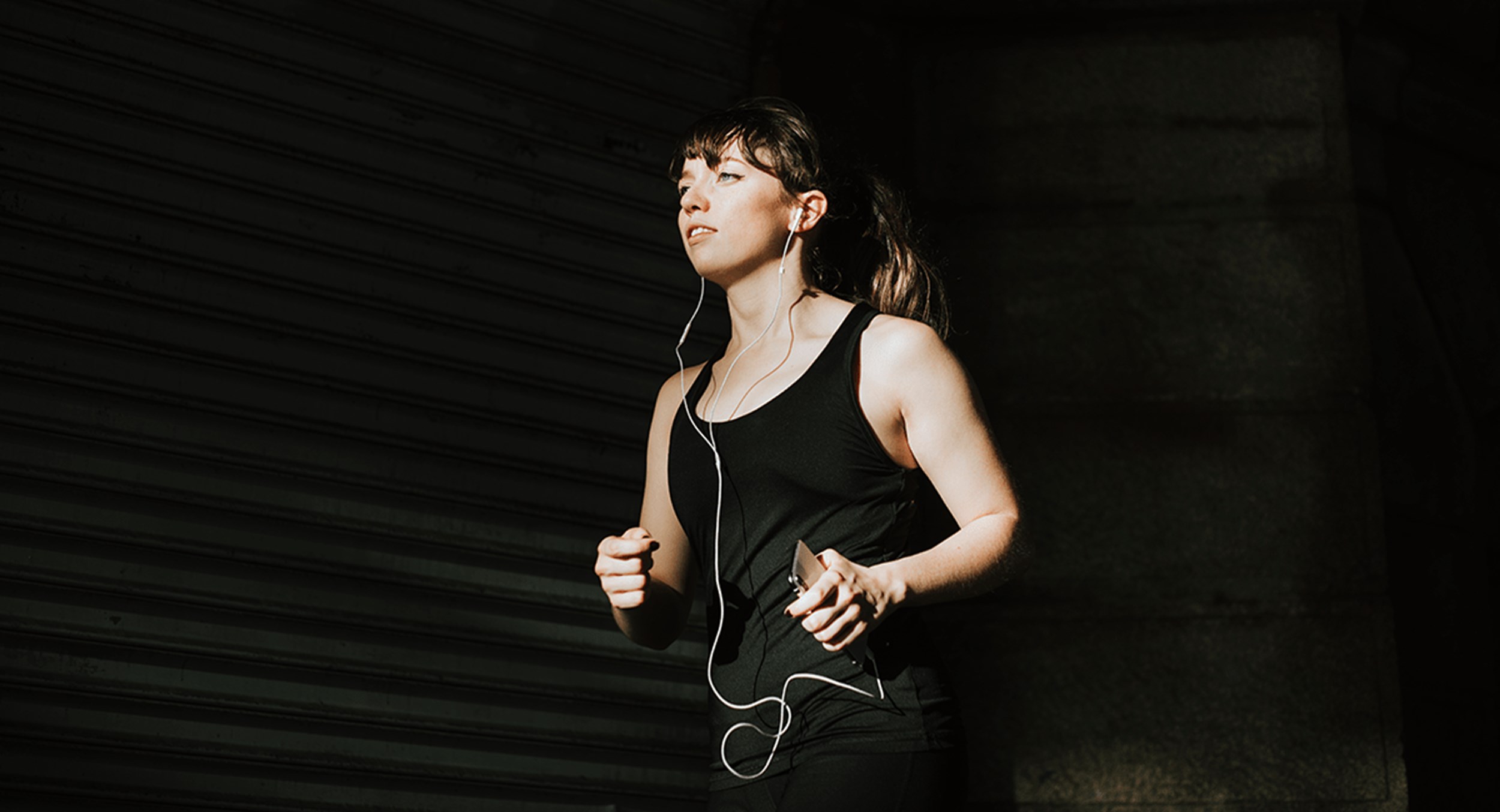 Woman running listening to headphones