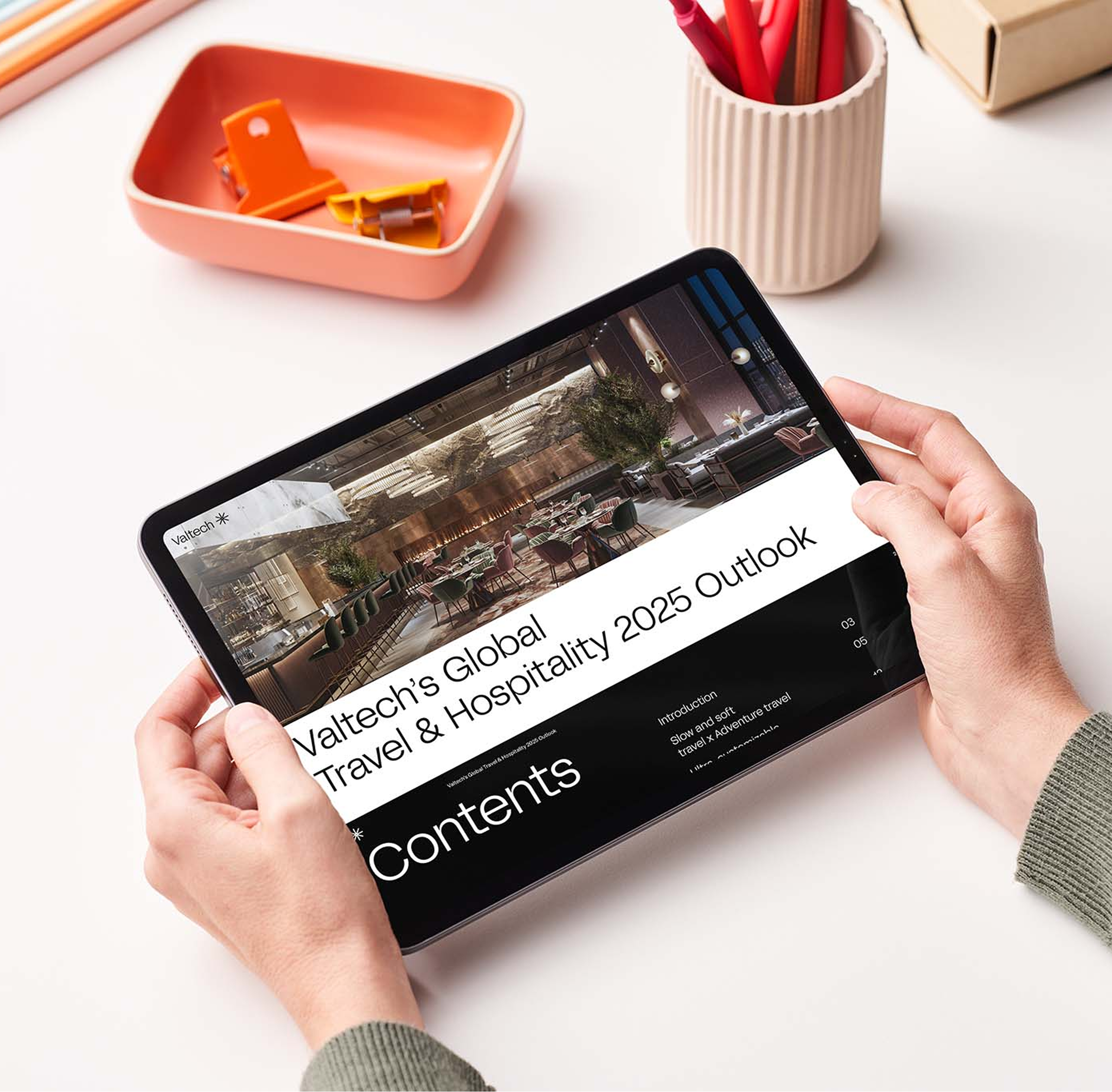 Person holding a tablet displaying Valtech’s Global Travel & Hospitality 2025 Outlook, highlighting industry trends and digital transformation insights.