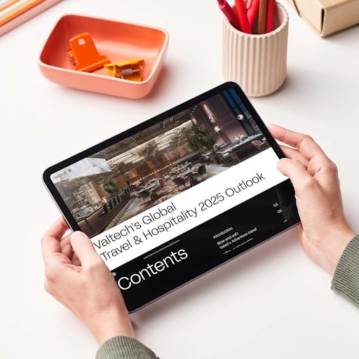 Person holding a tablet displaying Valtech’s Global Travel & Hospitality 2025 Outlook, highlighting industry trends and digital transformation insights.