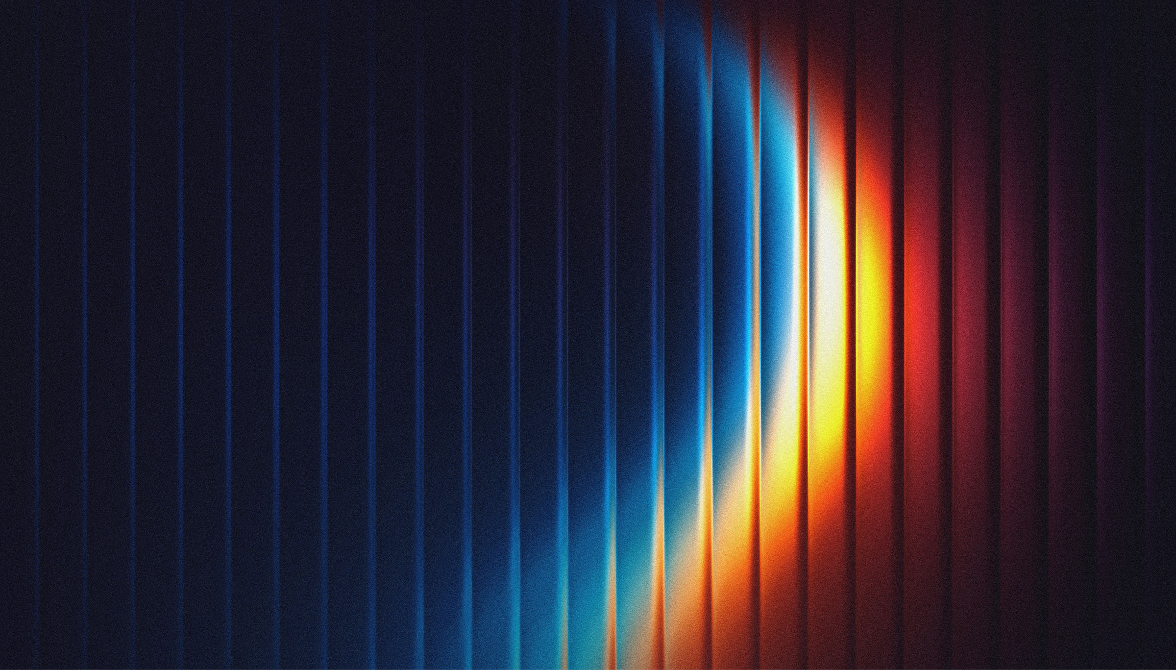 Abstract light arc in blue, orange and red sweeping across dark textured vertical ridges