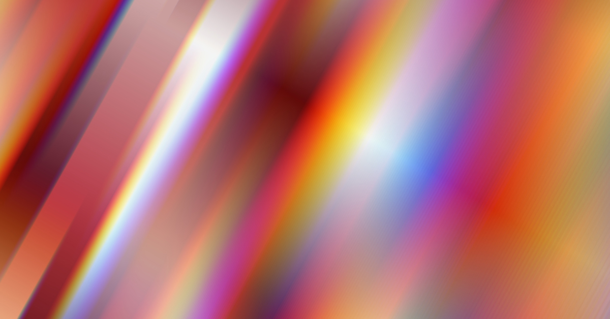 An abstract image featuring vibrant streaks of light in a range of colors, including red, orange, purple, and blue. The diagonal lines create a sense of motion and energy, blending smoothly into one another. The design has a futuristic and dynamic feel, representing creativity, innovation, or digital transformation.