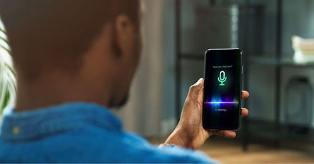 Man using AI smart voice assistant on a smartphone.