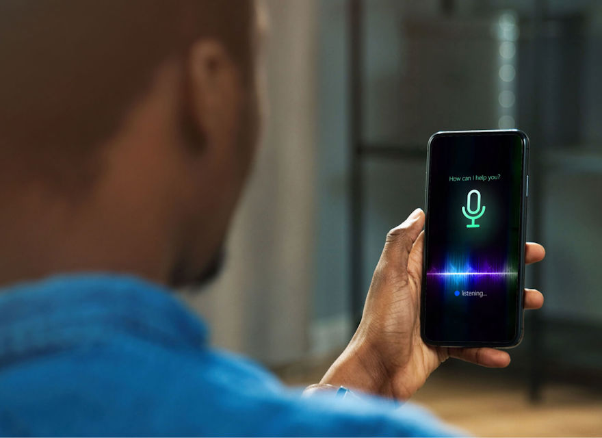Man using AI smart voice assistant on a smartphone.
