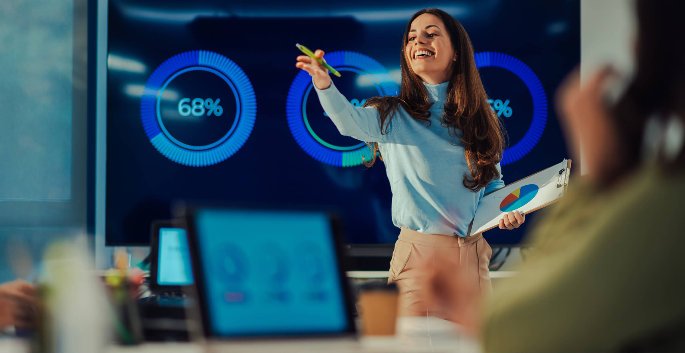 Confident businesswoman presenting data analytics to a team, showcasing leadership and effective communication