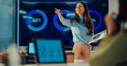 Confident businesswoman presenting data analytics to a team, showcasing leadership and effective communication