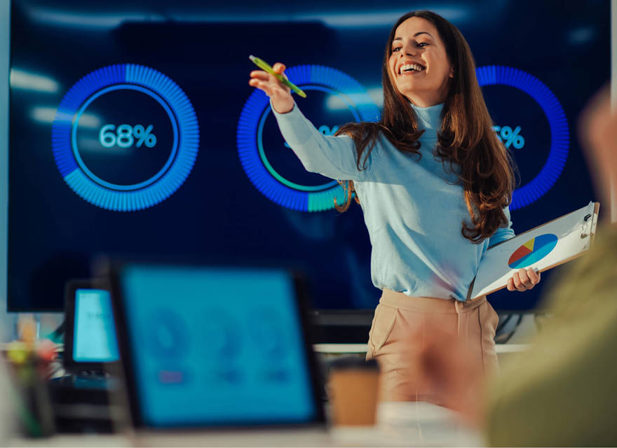 Confident businesswoman presenting data analytics to a team, showcasing leadership and effective communication