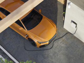 A top-down view of an orange electric car charging at a home charging station. The car is parked in a driveway, connected to a wall-mounted charging unit. The setting is modern and clean, with part of the car shaded by a wooden structure. The image highlights sustainability and the use of electric vehicles in residential environments.