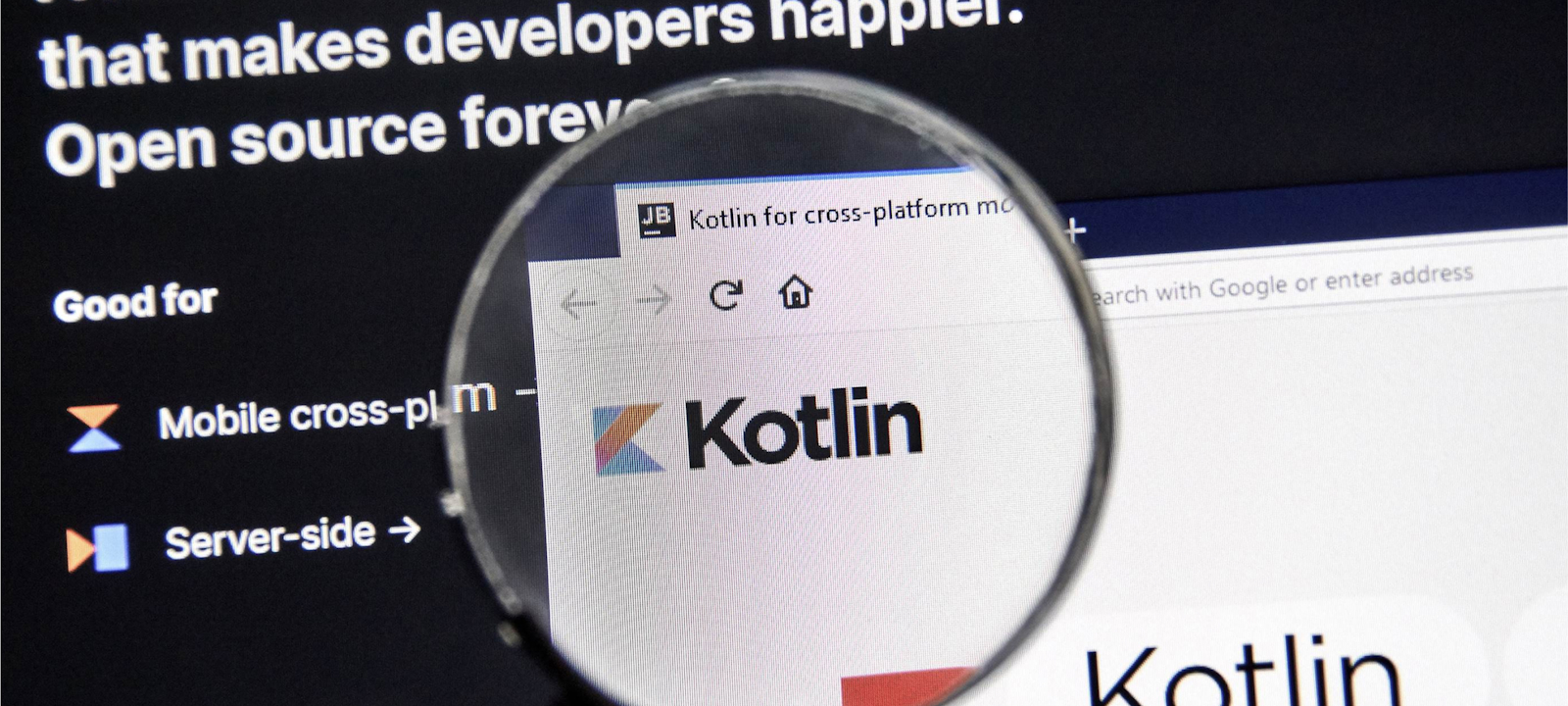 A close-up of a computer screen showing the Kotlin programming language website through a magnifying glass. The screen highlights that Kotlin is a modern, open-source programming language, with emphasis on mobile cross-platform and server-side development. The magnified section focuses on the Kotlin logo, reinforcing its relevance in the developer community. The image represents the importance of Kotlin in modern software development.