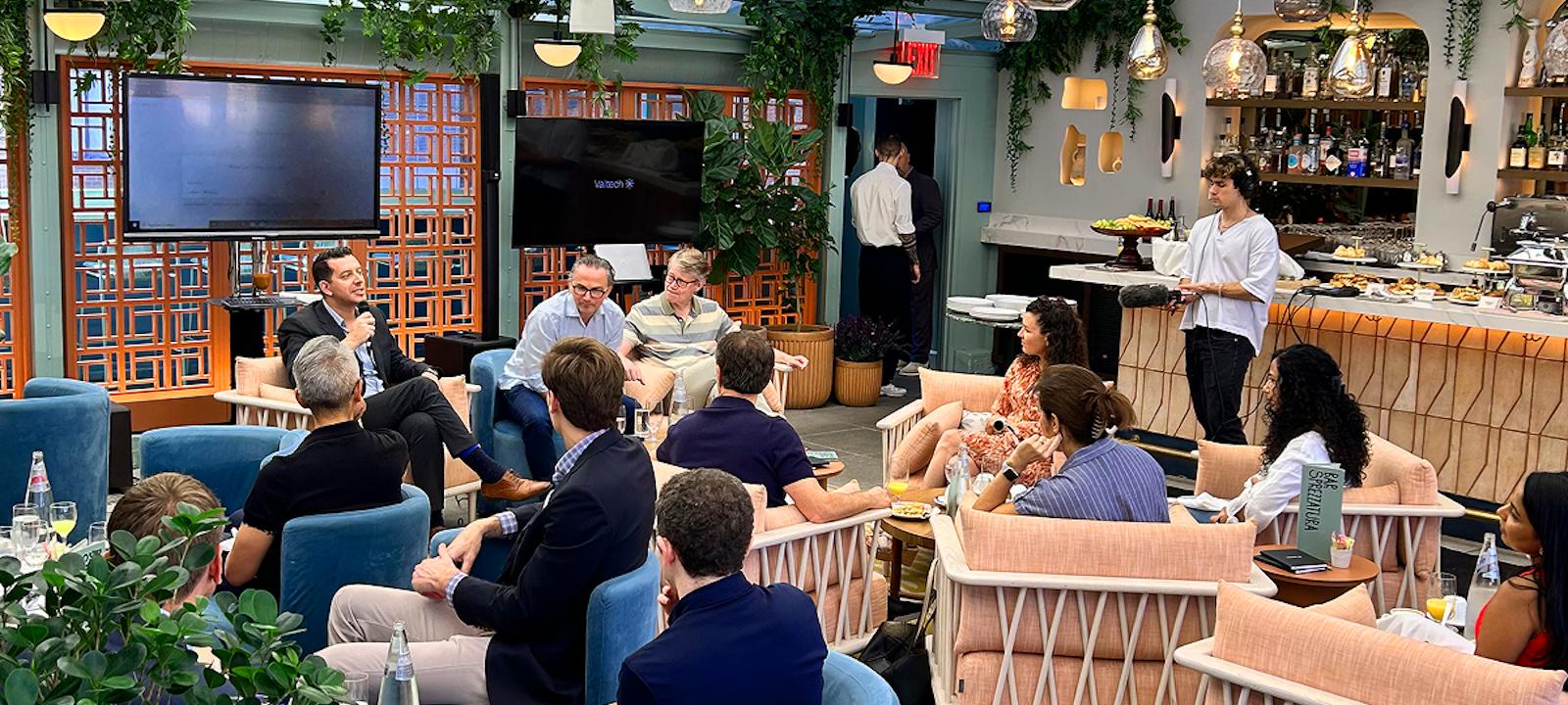 A group of people enjoying a meal together, sitting in chairs at a cozy restaurant.