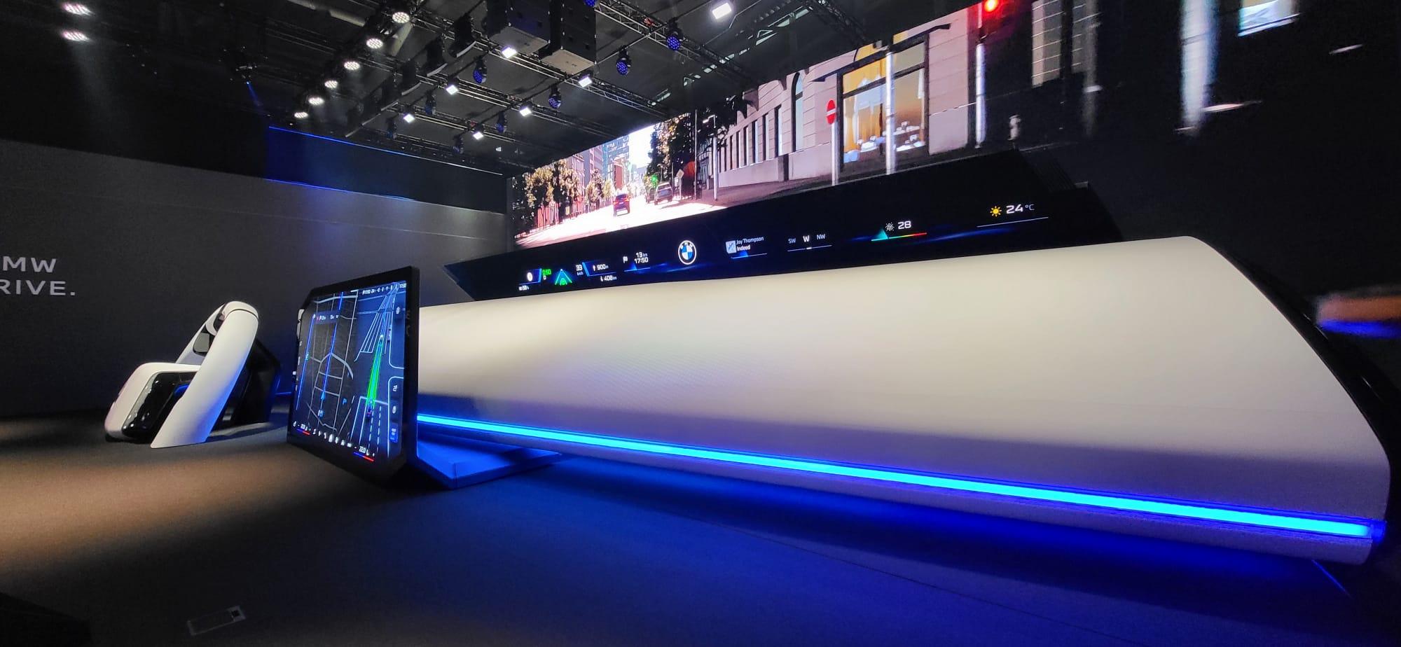 A futuristic display looms as a man stands before it, engaged with the innovative technology presented.