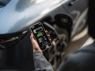 A sleek electric vehicle charging at a futuristic station, showcasing the evolution of sustainable transportation.