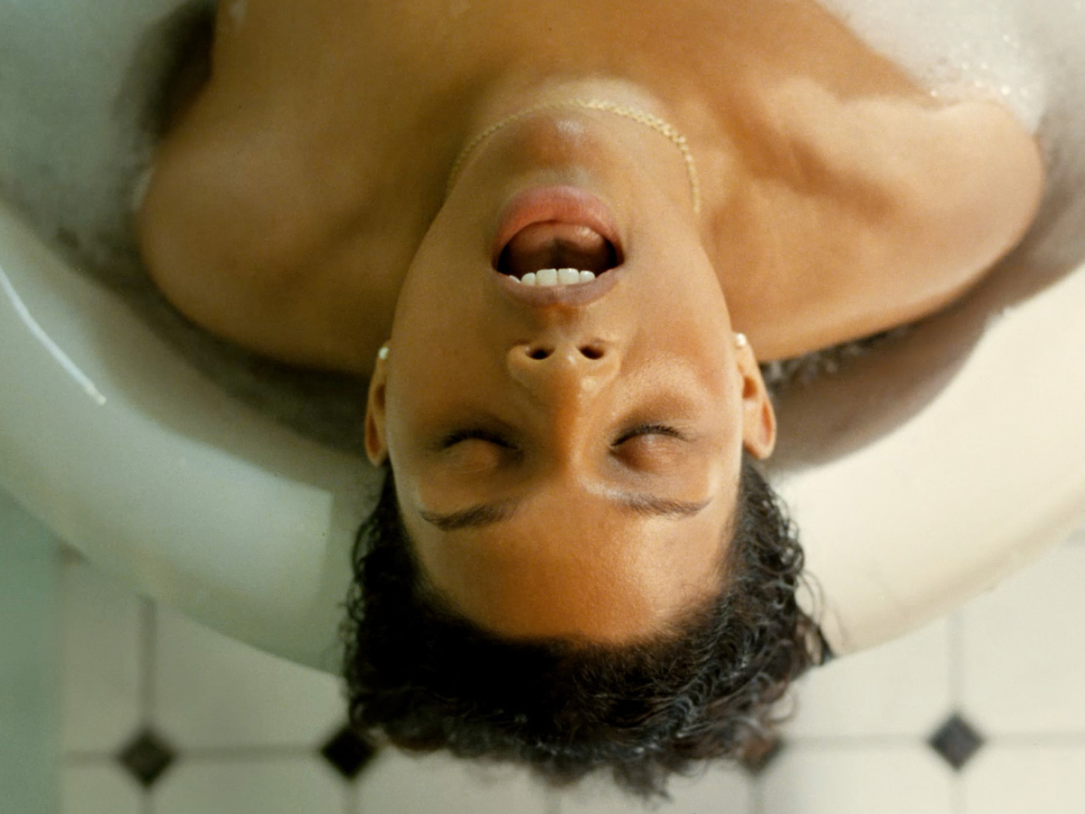 A woman relaxing in a bathtub, surrounded by bubbles and candles, enjoying a moment of tranquility  