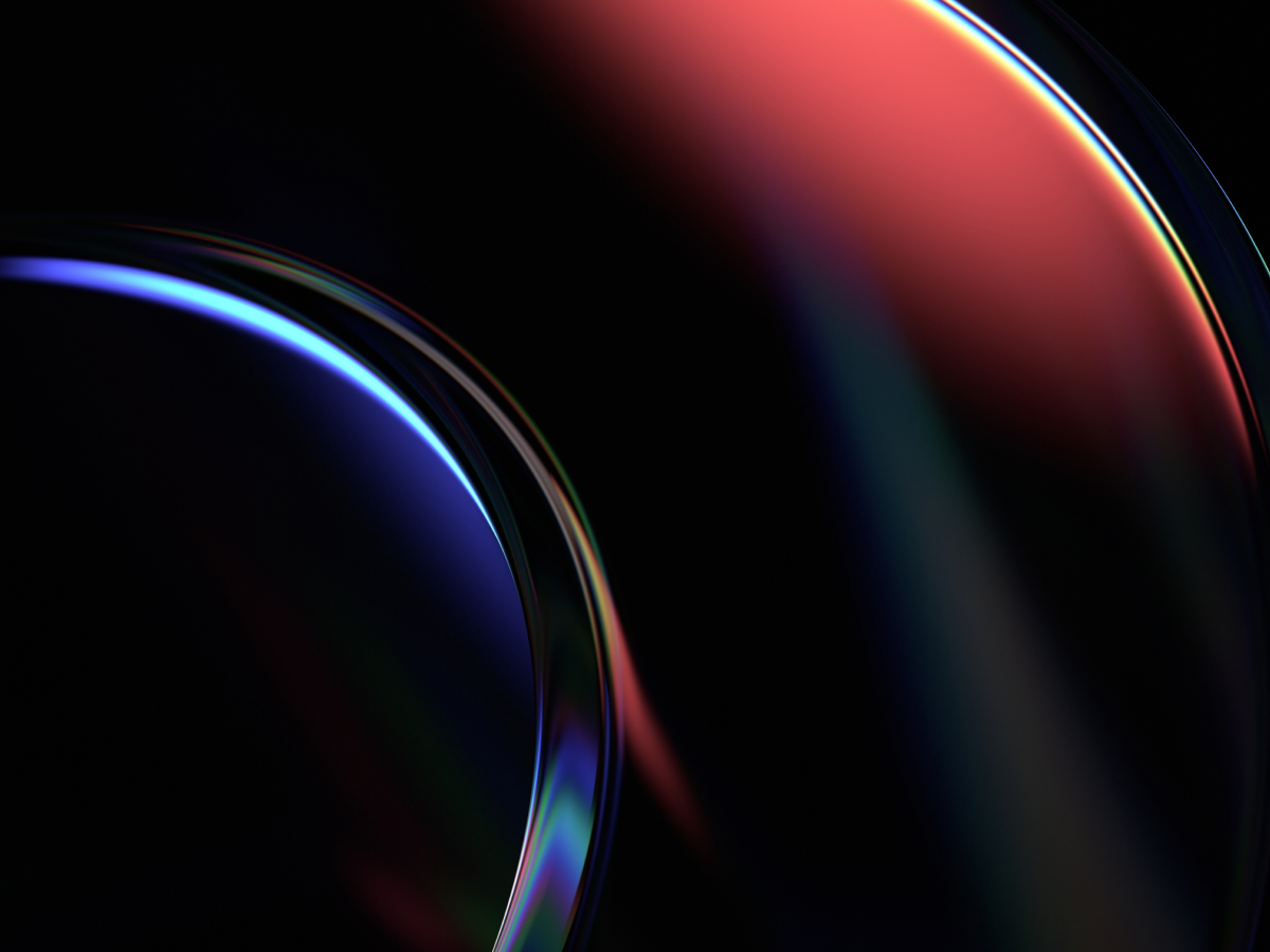 An abstract image featuring smooth, curved shapes in a dark background, illuminated by a blend of deep blue and red hues. The glossy, reflective surface of the shapes adds a sense of depth and dimension, with the colors softly transitioning from one to the other. The light accents highlight the curvature, creating a sleek, futuristic feel. The dark setting enhances the vibrancy of the colors, giving the image a dynamic and modern look, often associated with technology, data, and innovation.