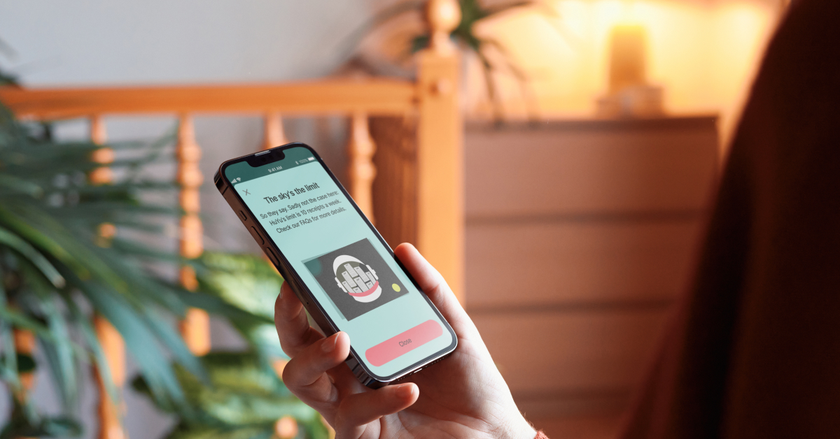  A person is holding a smartphone and viewing a screen with the title "The Sky's the limit!"