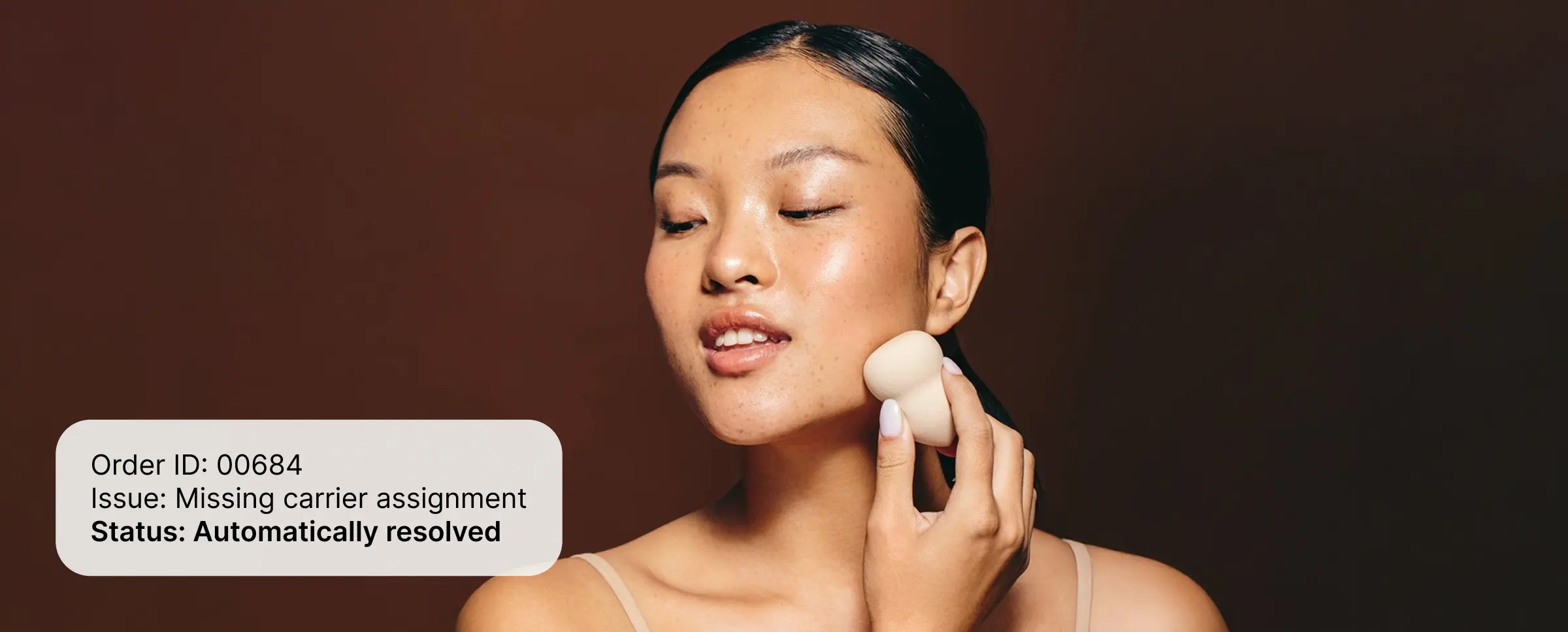 Person applying makeup sponge to jawline with overlay showing order issue automatically resolved.