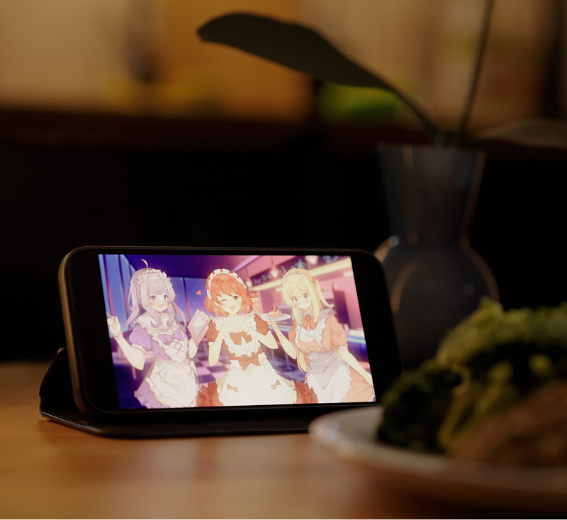 Mobile phone showing three anime characters