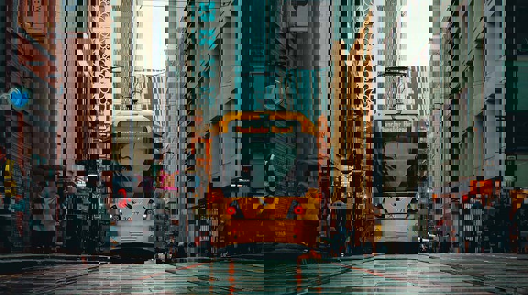 Rainy city of Manchester with front view of a yellow train