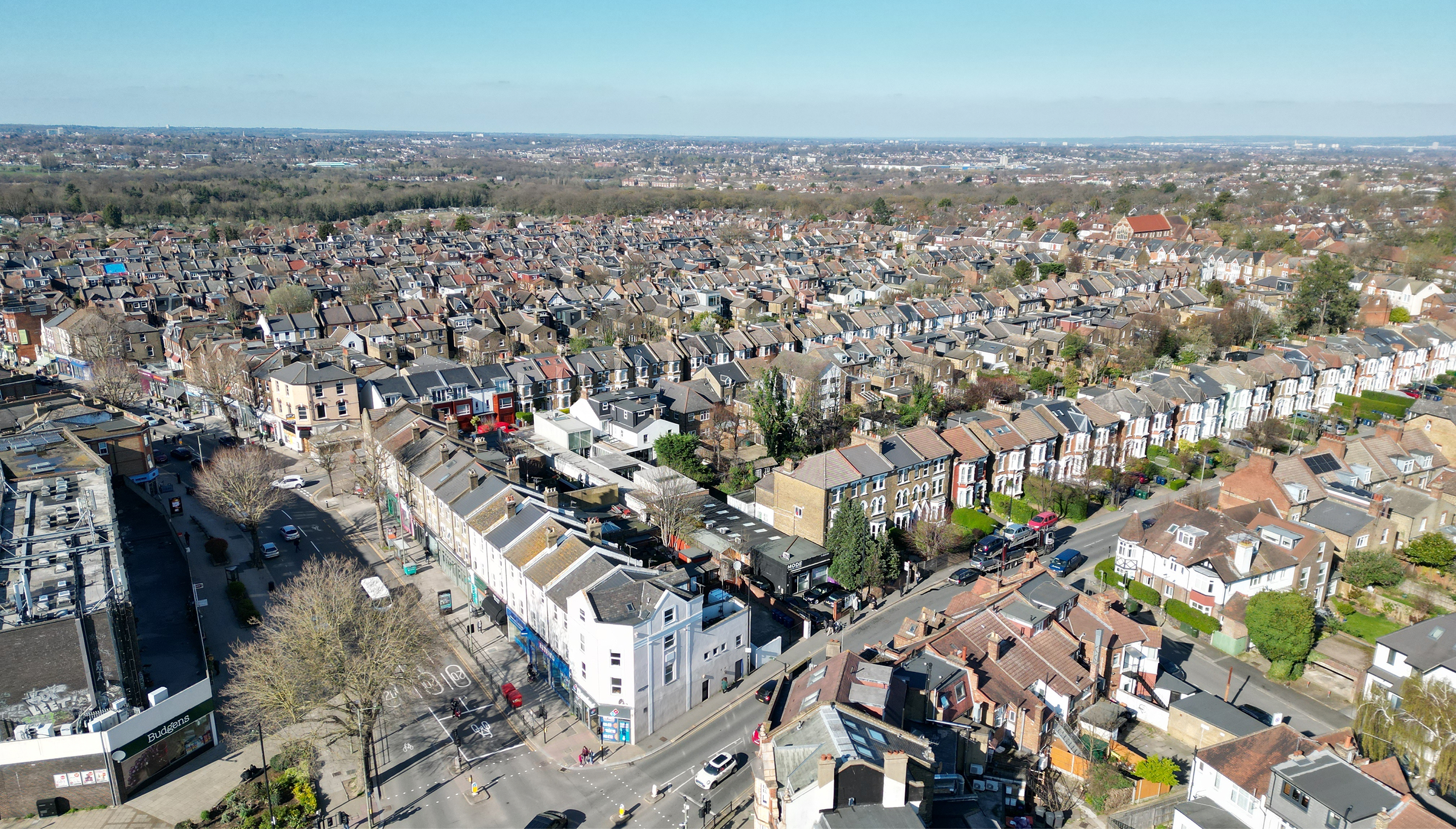 Aerial view of a city filled with numerous houses, showcasing a vibrant urban landscape from above