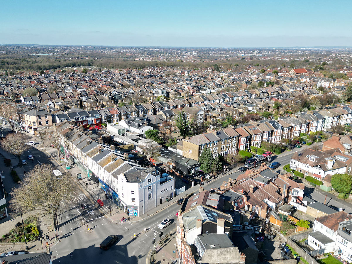 Aerial view of a city filled with numerous houses, showcasing a vibrant urban landscape from above