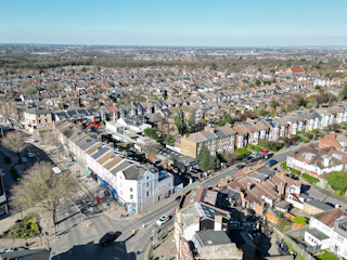 Aerial view of a city filled with numerous houses, showcasing a vibrant urban landscape from above