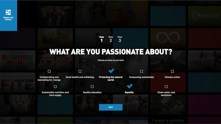 Screenshot of the customization of the Action Hub experience, where a big header reads, “WHAT ARE YOU PASSIONATE ABOUT?” with the text “Choose as many as you want” below it. Below there are various checkboxes the user can pick from, such as “Collaborating and innovating for change”, “Good health and wellbeing”, “Protecting the natural world” and “Equality”. At the bottom, there’s a blue “Next” button saying “Next”. In the top left there’s a blue area with a grid icon and the text “Explore all actions”.