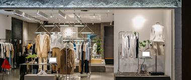 Contemporary clothing store with digital displays and stylish apparel racks, highlighting unified omnichannel retail experiences.