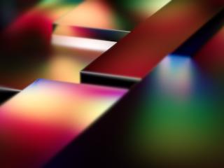 An abstract image featuring a series of geometric shapes with sleek surfaces, illuminated by a gradient of vibrant colors, including red, pink, yellow, green, and blue.