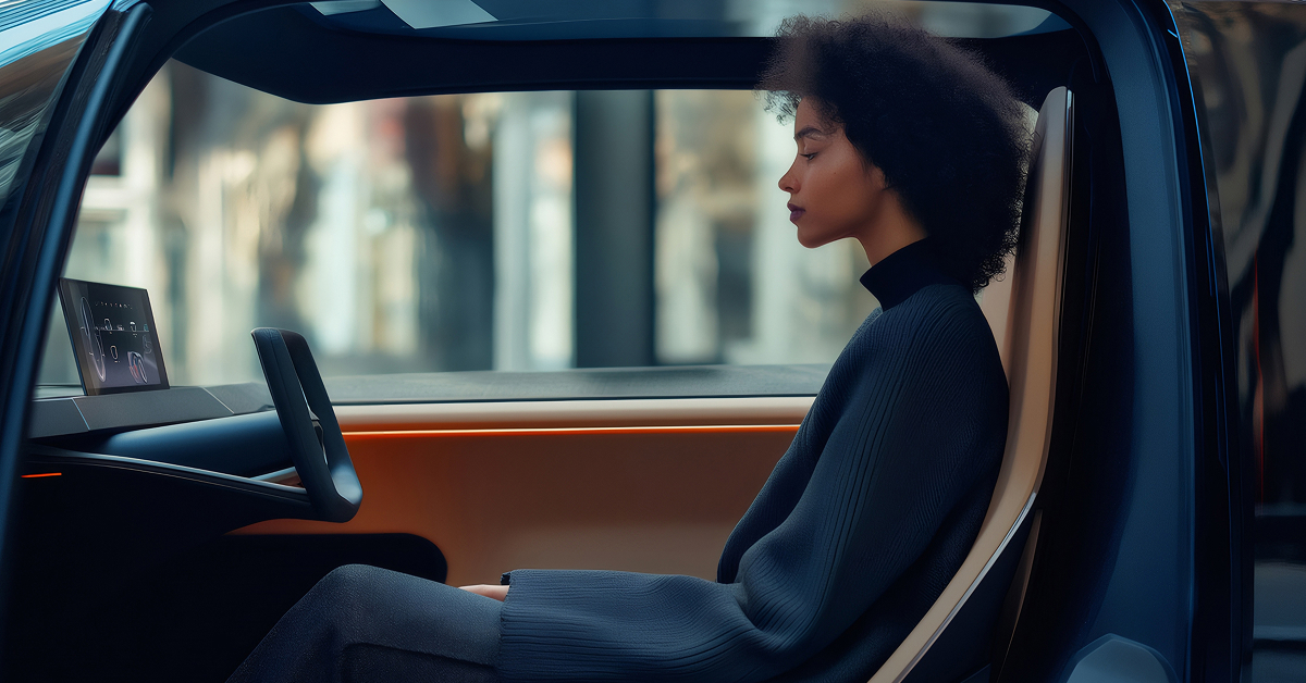 A woman seated in the driver's seat of a car, focused on the road ahead.