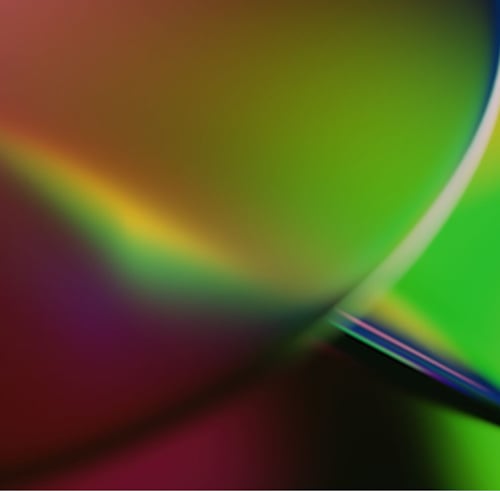 Abstract composition of vibrant gradient colors with curved light reflections, representing digital acceleration, innovation, and emerging technologies.