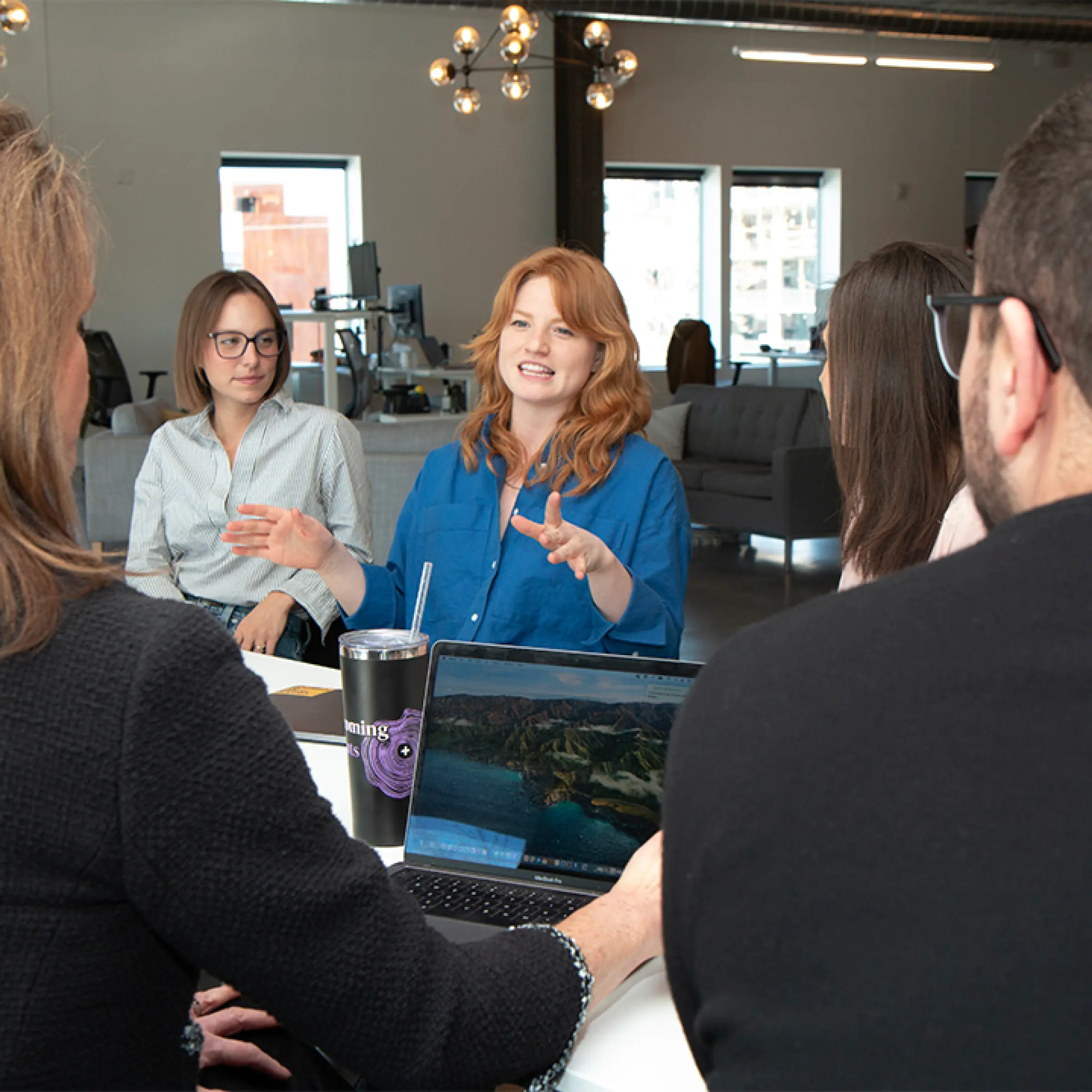 Transformative partnership group meeting in modern office Valtech
